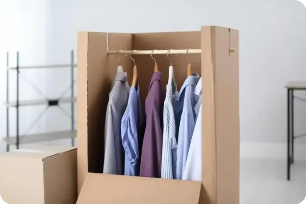 Open wardrobe moving box with clothes hanging inside