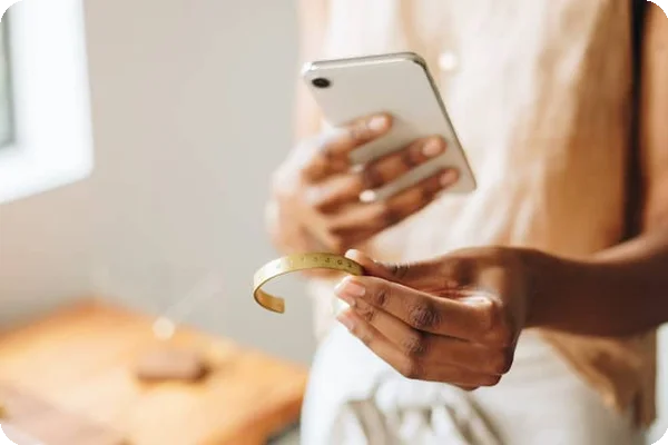 a woman takes a picture of her bracelet for insurance and inventory purposes