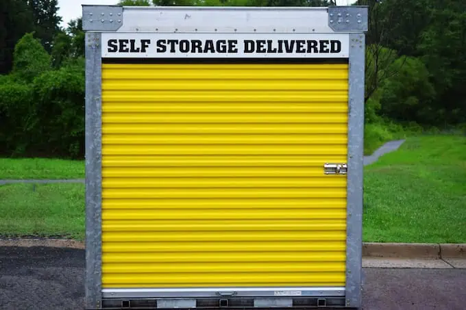 A moving container like PODS with a yellow door