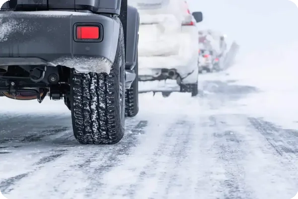 Cars driving on a snow-covered road during winter