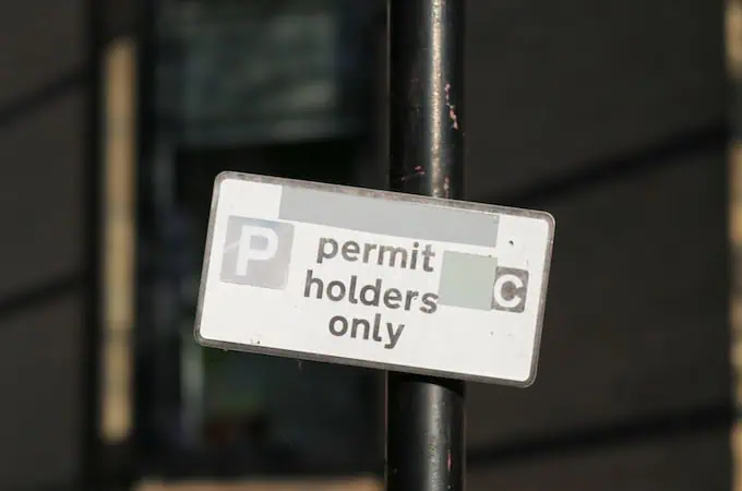 A sign designating parking space that reads "Permit Holders Only"