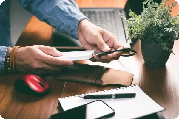 Person plugging in external hard drive to secure digital assets.