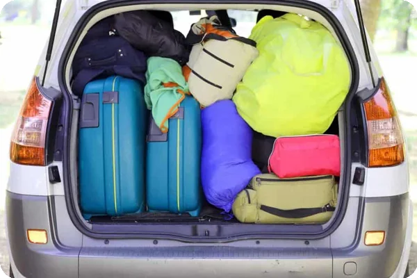 A car is packed with suitcases and duffle bags of varying sizes, which can be used instead of moving boxes