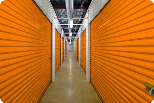 Row of climate-controlled self-storage units with secure orange roll-up doors