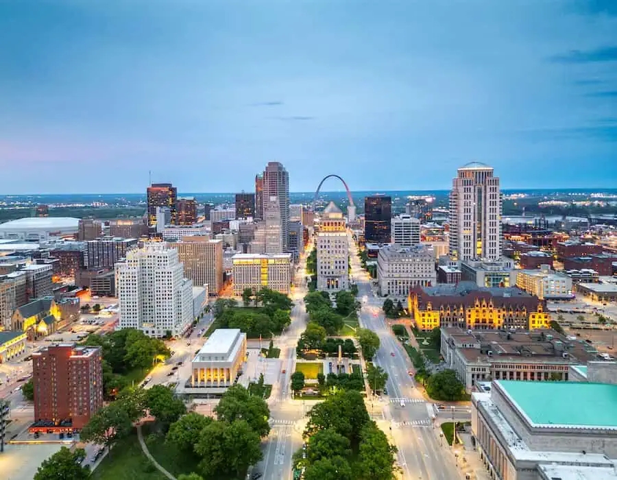 Evening skyline of Chesterfield, MO with high-rises and tree-lined roads.