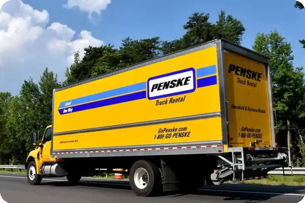 Yellow Penske rental truck on the road