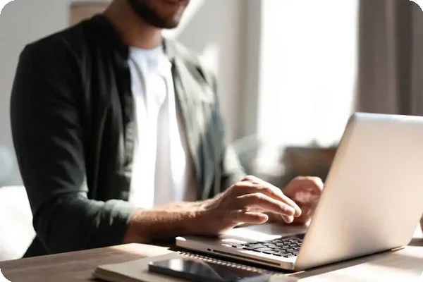 Person researching moving companies online using a laptop at home