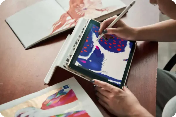 Artist drawing colorful digital illustration on a tablet with stylus, showcasing creative digital art design process.