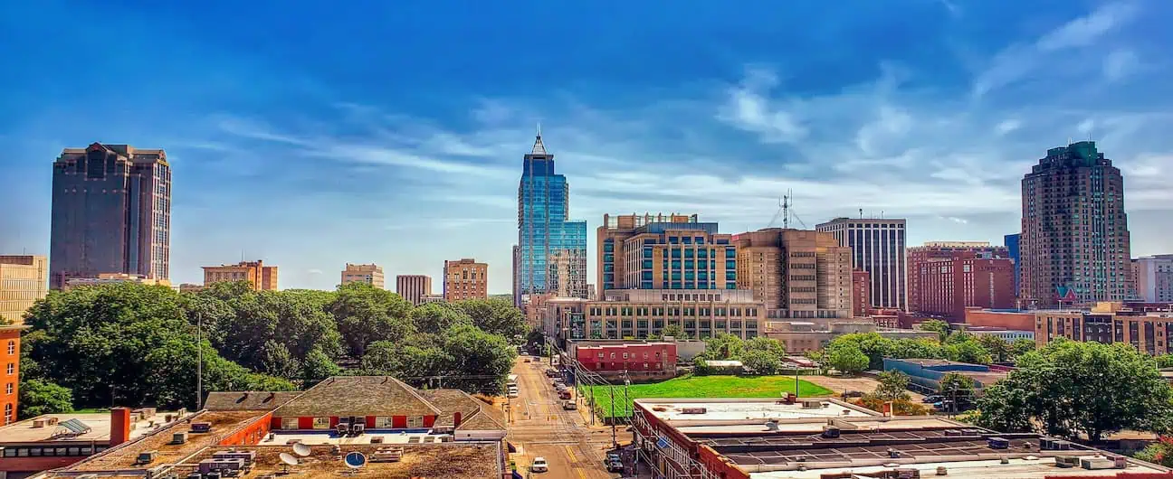 Bright cityscape in Wilmington, NC showcasing varied architecture and green spaces.