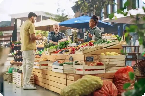 People shopping at an outdoor farmers market