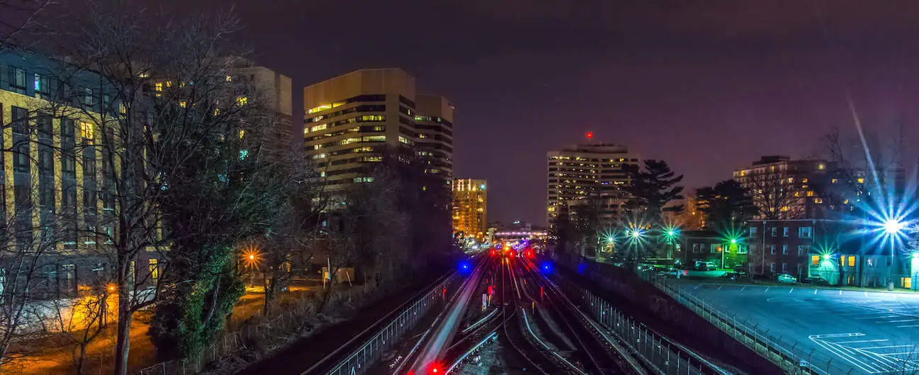 A view of the Silver Spring train station and skyline in Silver Spring, MD at night