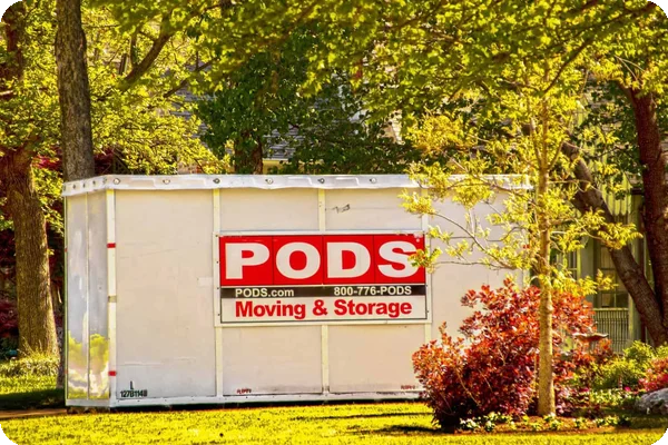 A PODS container sits in a residential driveway