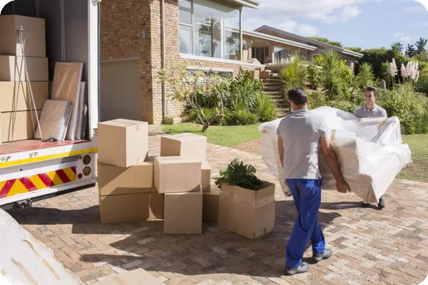A family loading boxes into a moving truck during a hot summer day with sunshine and clear skies