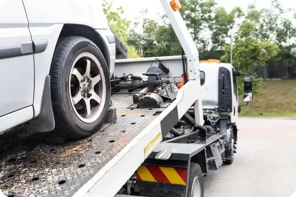 A tow truck providing roadside assistance to a broken-down car