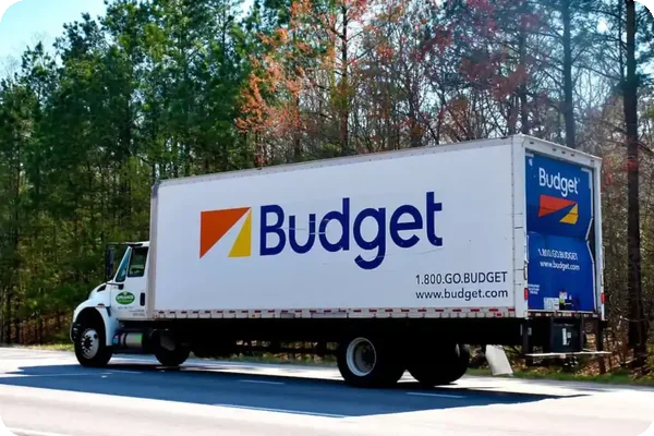 Budget rental truck driving on the highway for moving services