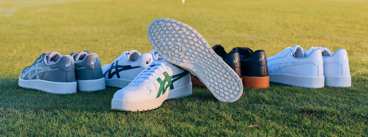 ASICS Japan S Golf shoes on the grass. 