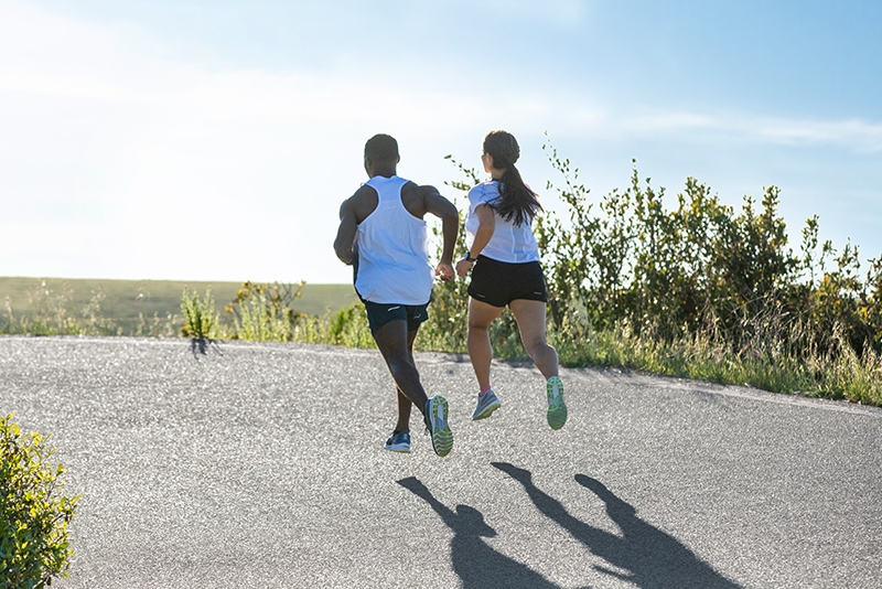 Two people running on an outdoor path