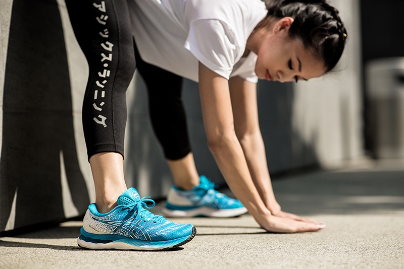 Woman in sporty gear stretching
