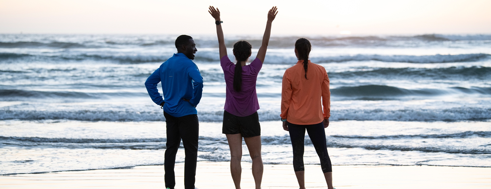 Three people standing next to water