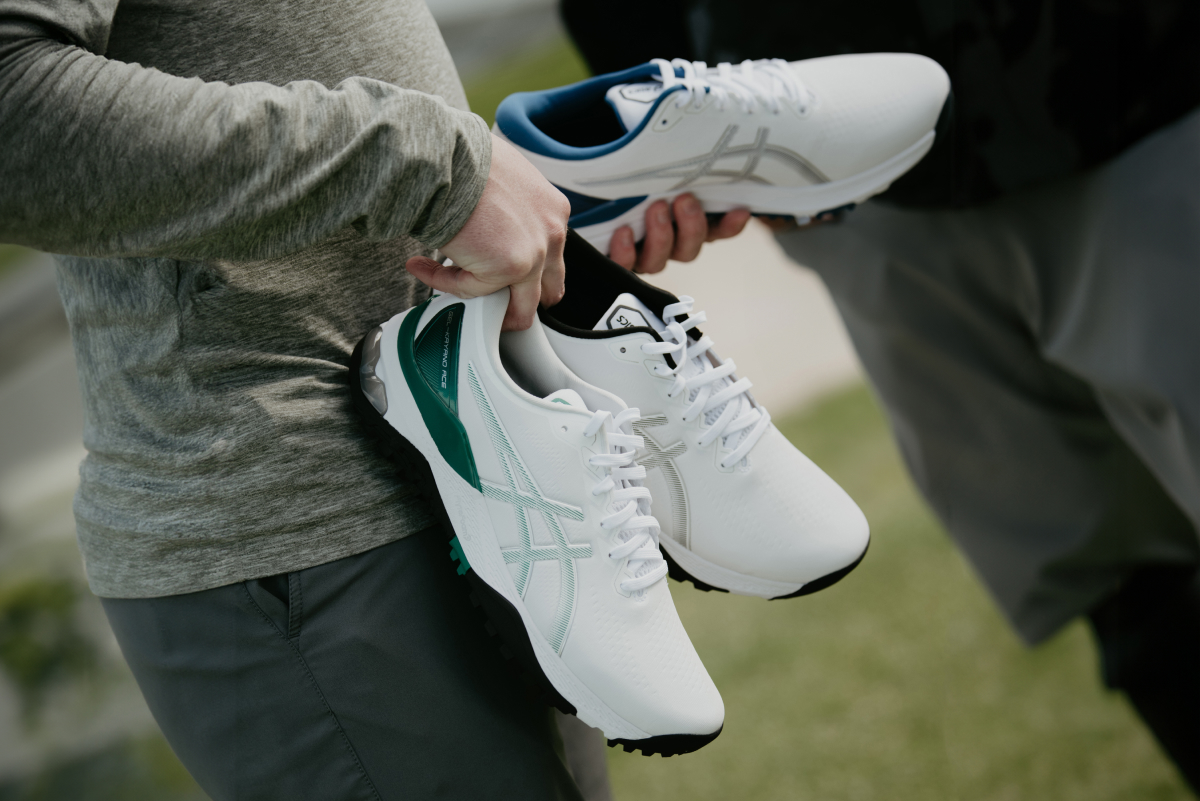 person holding different pairs of ASICS golf shoes