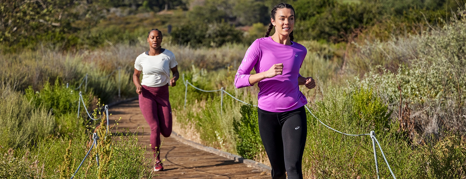 Two women running in a field