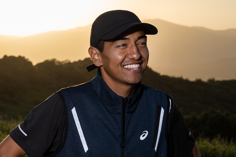 Man wearing an Asics hat