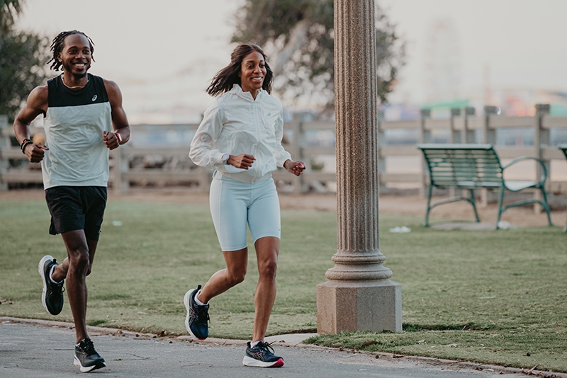 Man and Women running outside together in a park