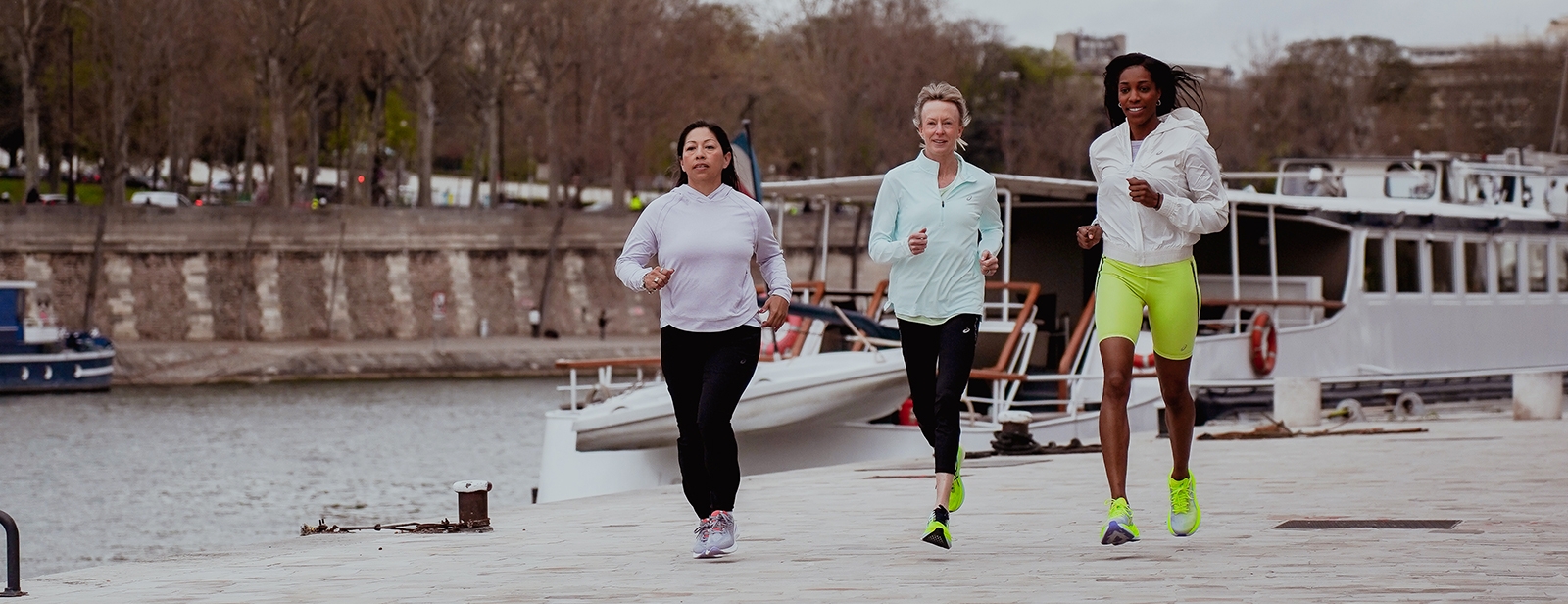 Three people running outside together