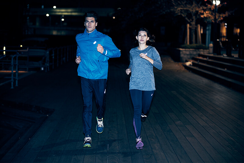 Men and woman jogging at night