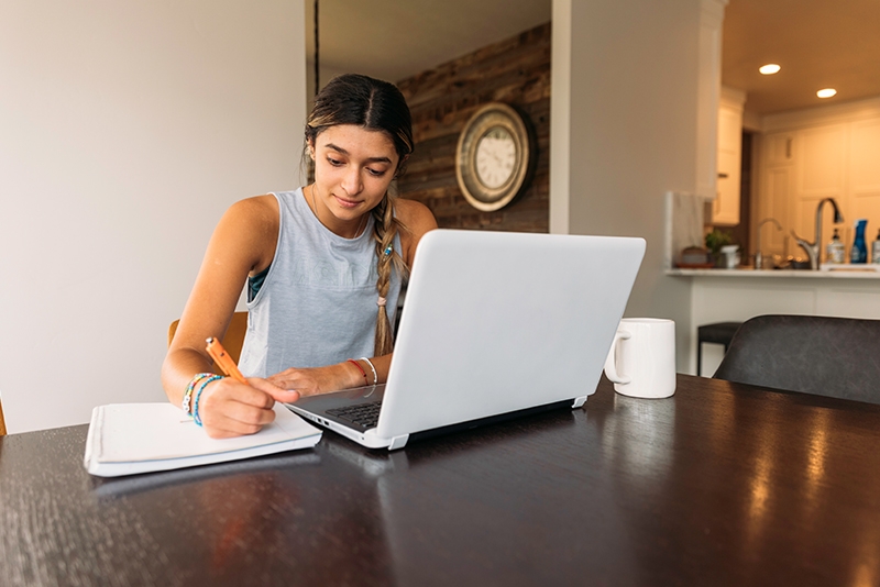 girl at laptop writing 