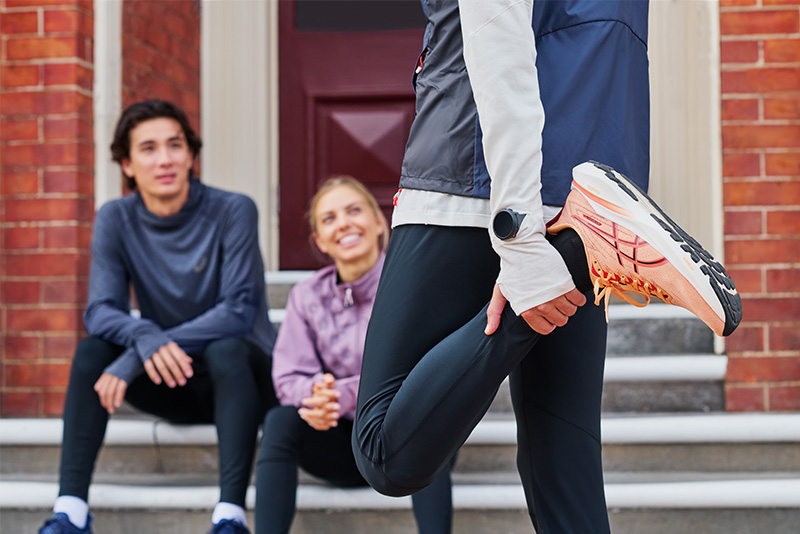 ASICS Runner stretching leg before a run. 