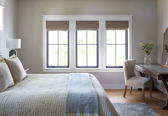 Bedroom with 3 fixed frame rectangular windows.