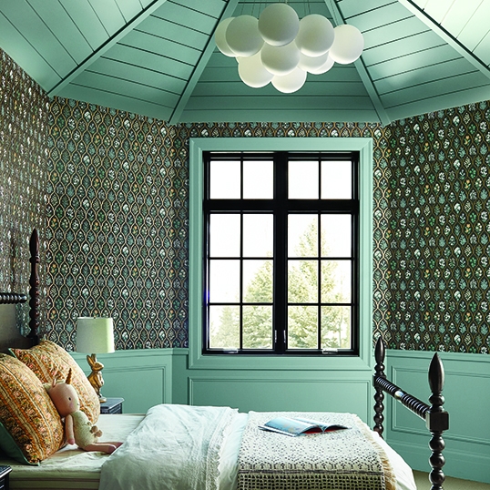 Bedroom in Idaho cottage home with newly installed black framed windows.