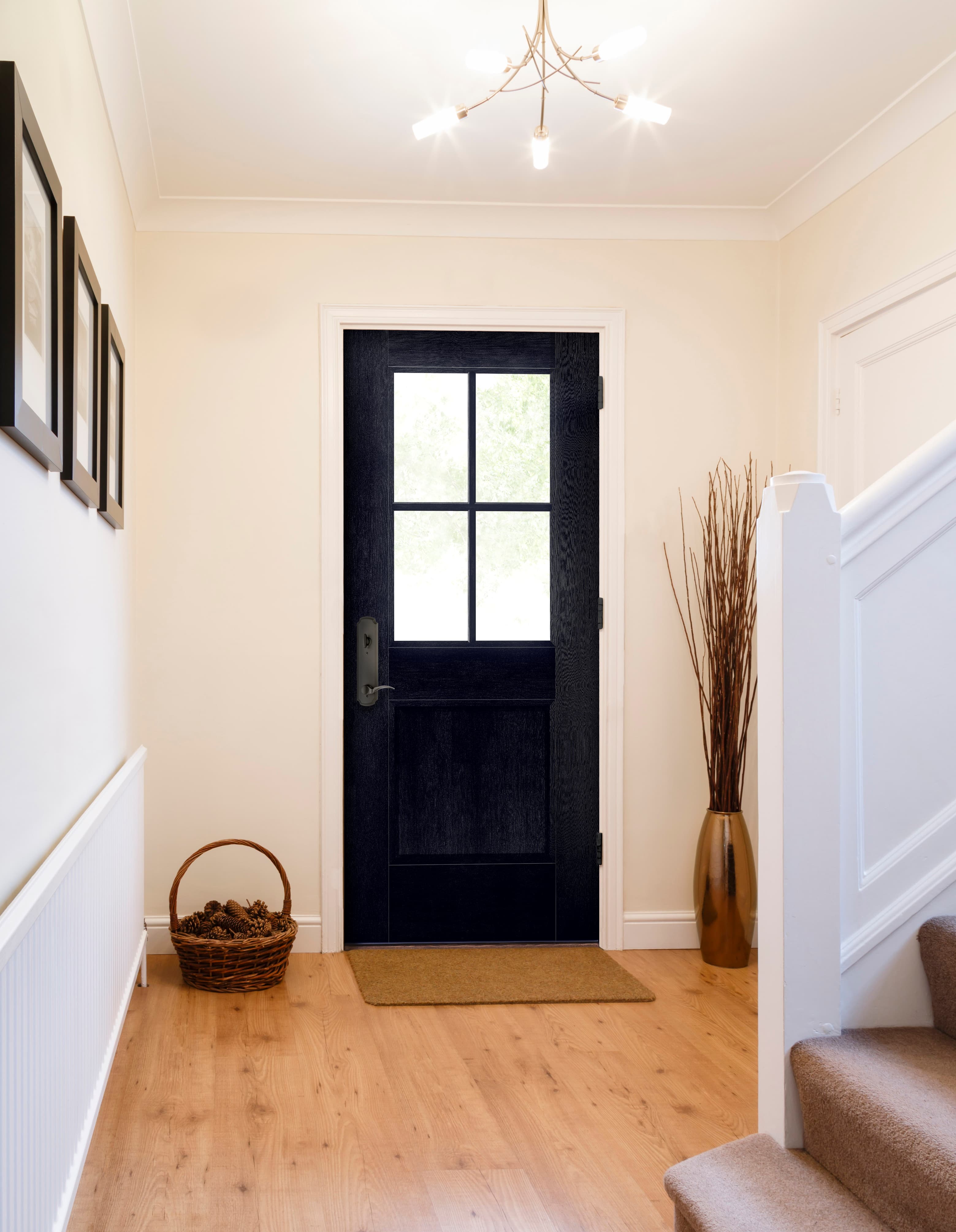 Black front door with classic grilles in farmhouse style entry