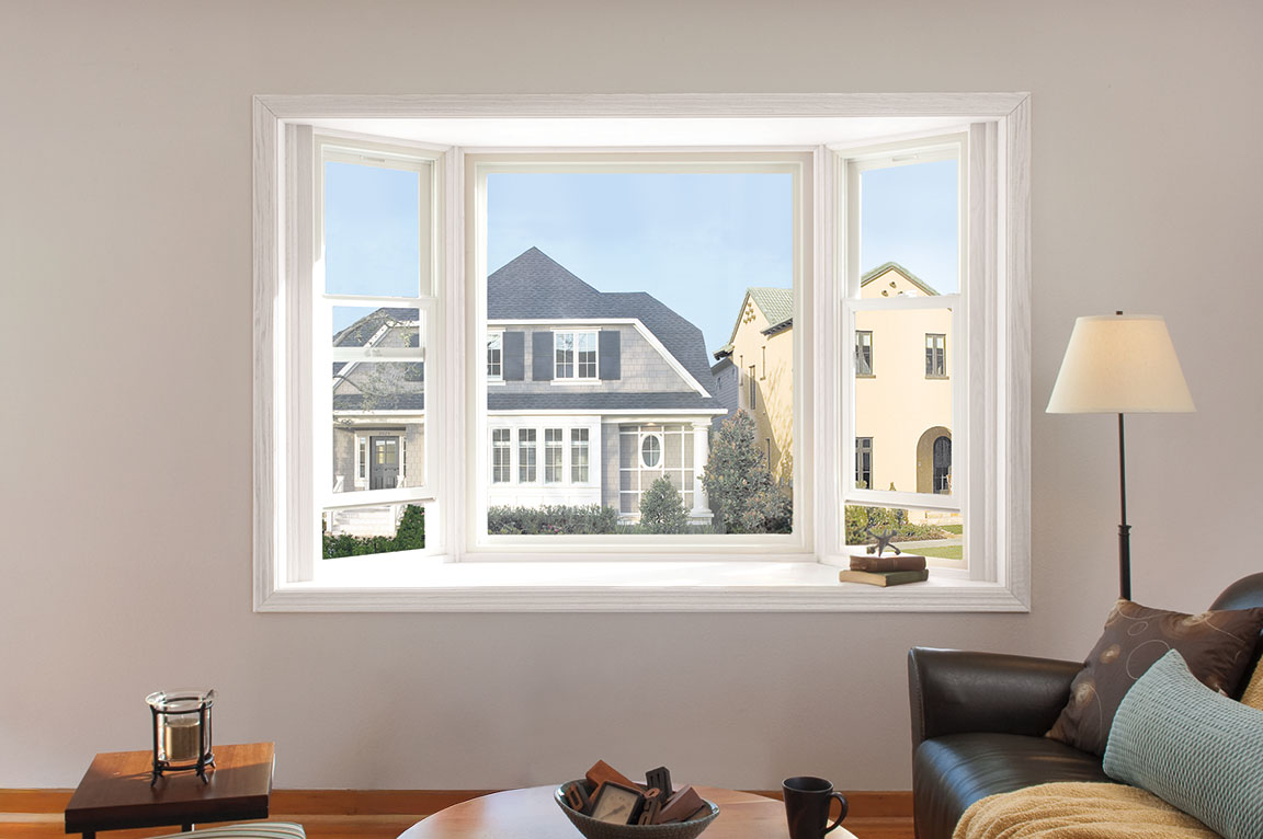 White bay windows in a contemporary living room with a view of neighbors' homes