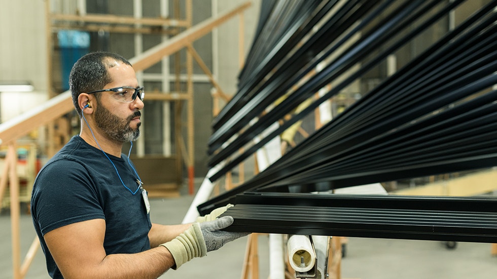 Pella worker assembling black shades