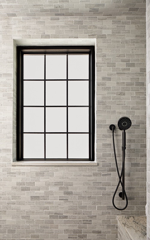 Shower with Black Paneled Casement Window Against Stone Gray Tile