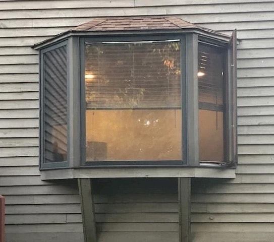 Outdated bay window on panel siding Waynesburg home.
