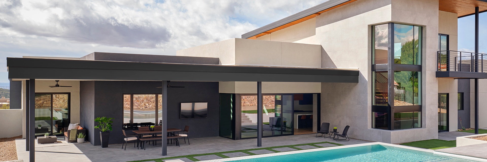Exterior shot of modern home's backyard with a pool.
