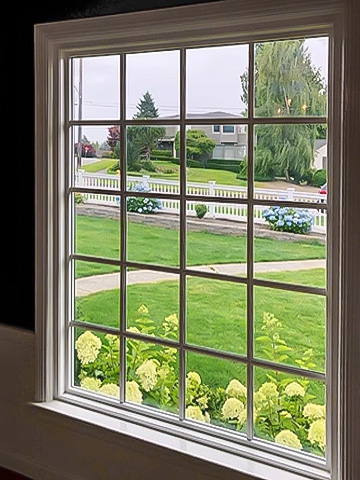 the interior view of a large picture window with traditional grilles-between-the-glass