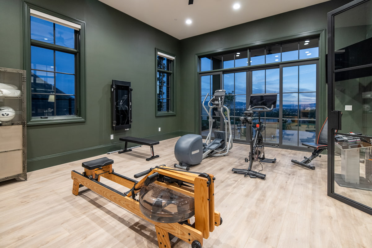 These home gym windows and door are painted green to match the walls.