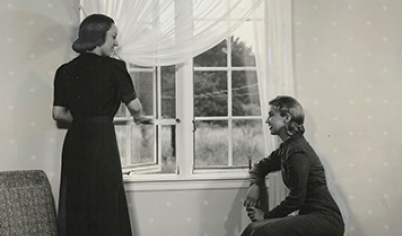 A 1937-released Pella Deluxe Casement window advertisement featuring two women standing by the window.