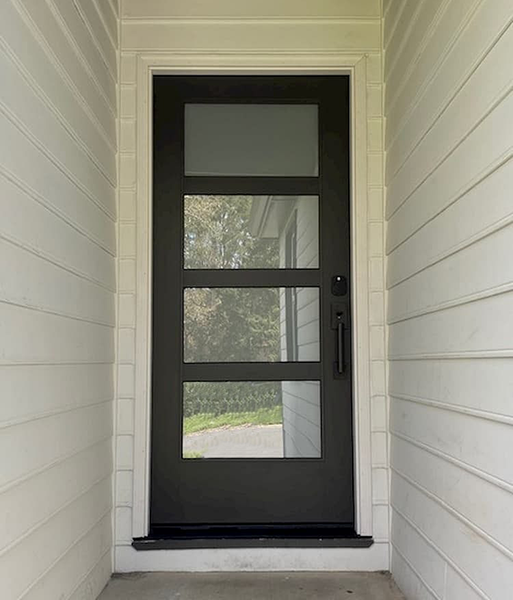 a Pella 4 light Contemporary front entry door reflecting the greenery outside the home