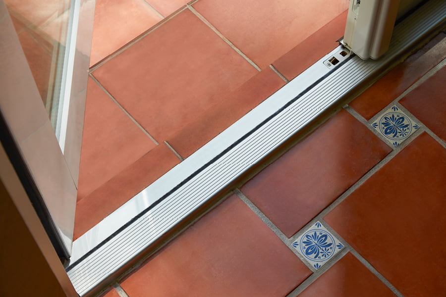 Hurricane Shield Patio Door Frame with red tile and blue accent piece