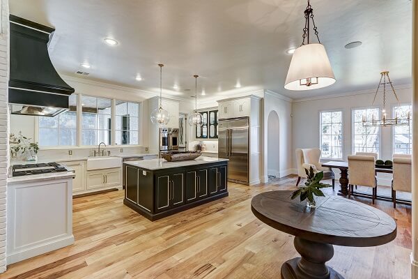 Rows of large casement windows light open concept kitchen and dining room area