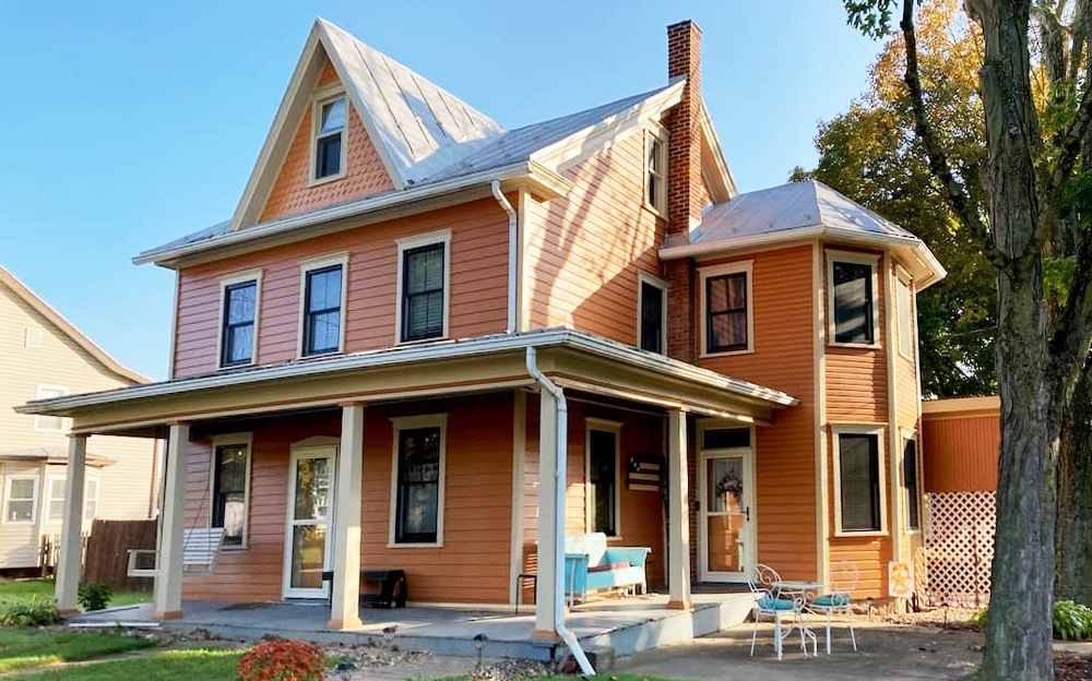 Exterior view of century-old Newport home with newly installed replacement windows by Pella.