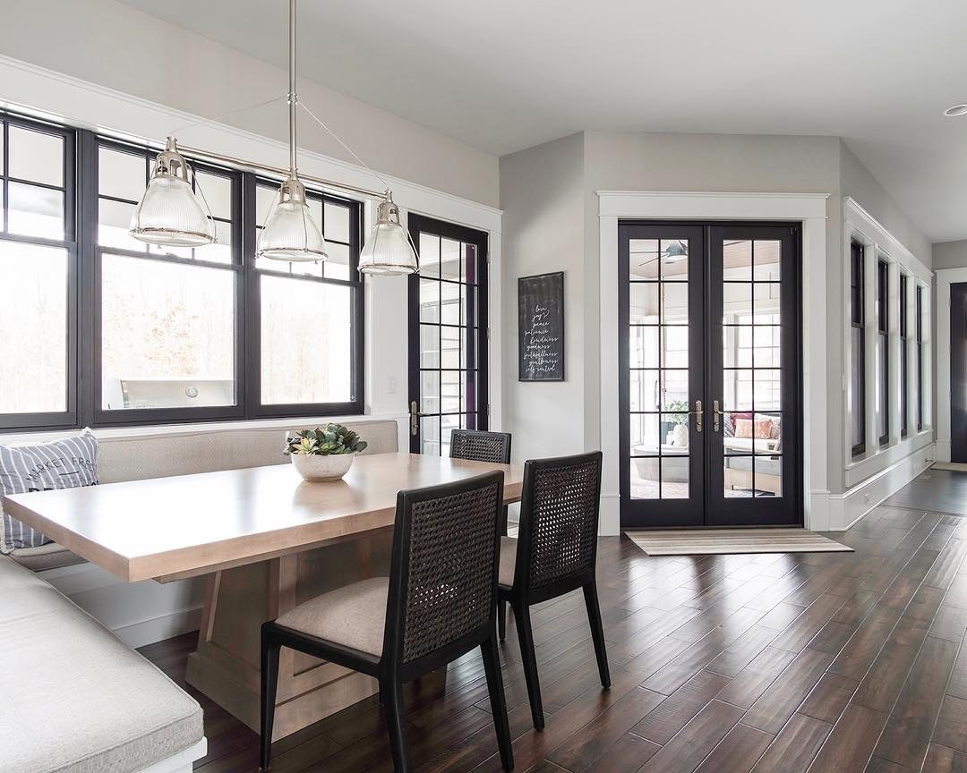 double-hung windows and french doors bring light into contemporary breakfast nook