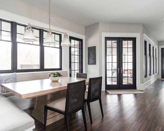double-hung windows and french doors bring light into contemporary breakfast nook
