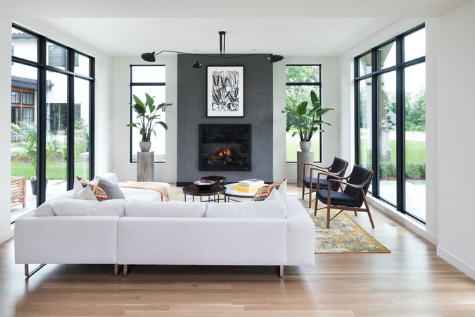 New home living room with custom floor-to-ceiling black fixed frame windows