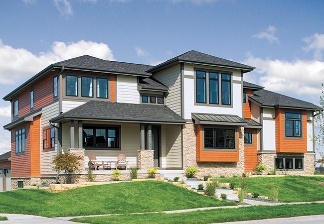Exterior view of a two-story home with contemporary black window frames